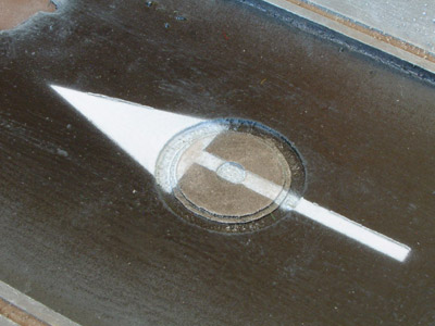 Close-up of an arrow painted on the street
